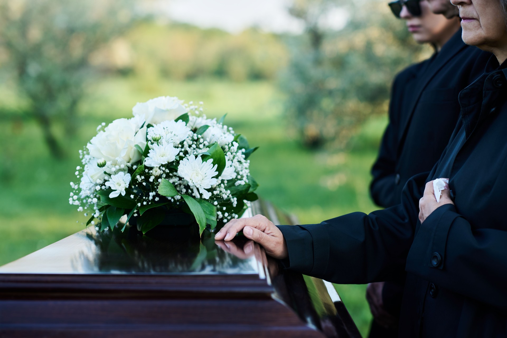 Cropped shot of mature woman and her family in mourning attire